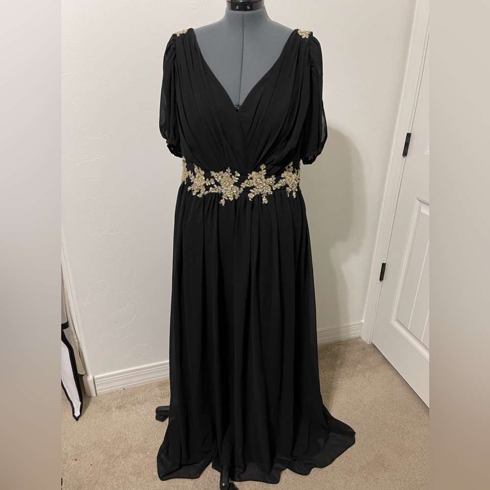 Floor length, black gown, open shoulders with gold accents